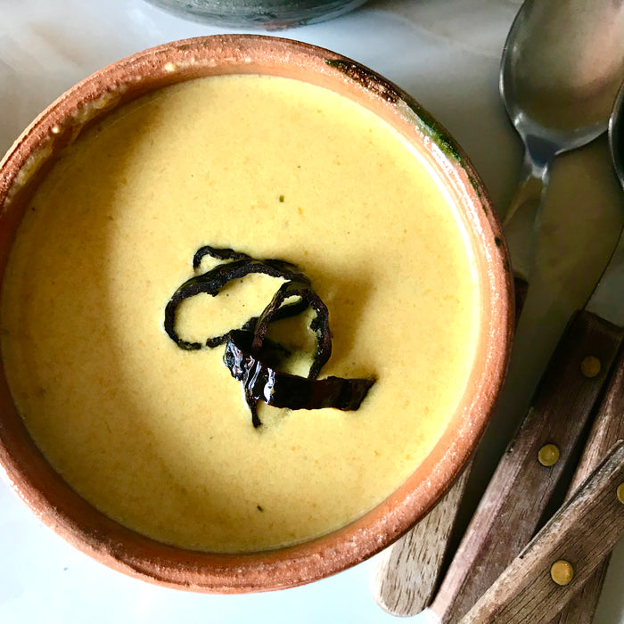Squash Blossom Creme Soup served in orange and gray glazed clay bowls from Mexico 1492