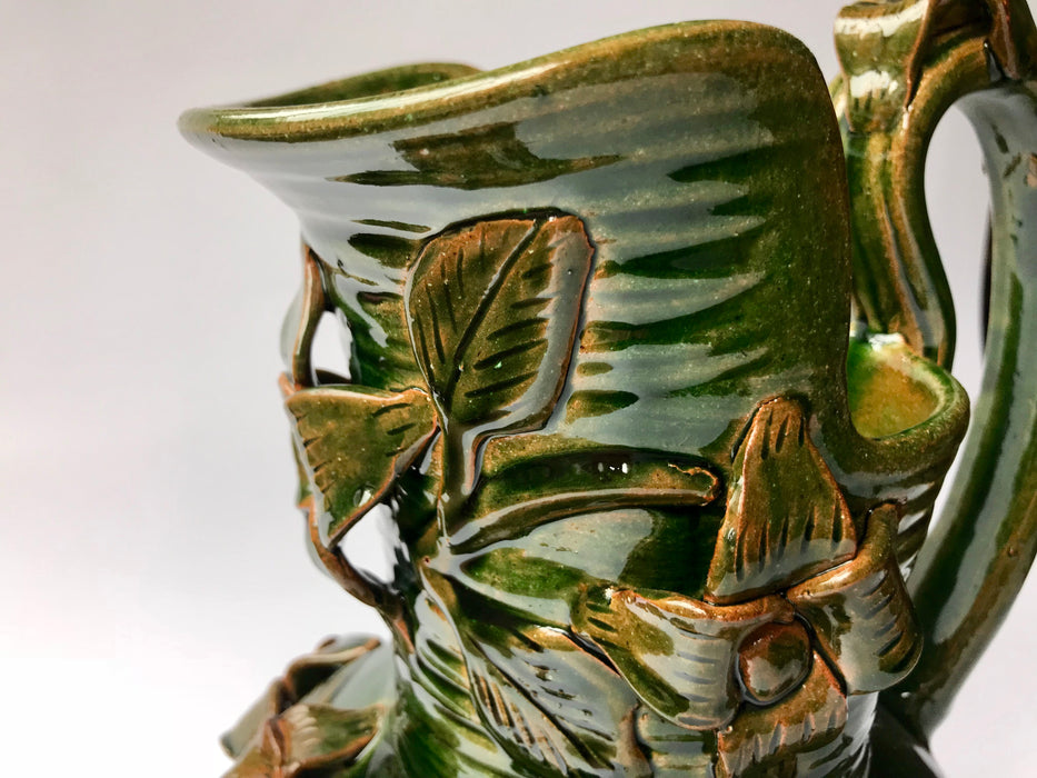 Green Glazed Clay Pitcher with Flower Ornaments