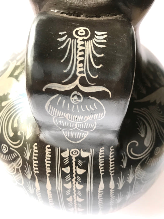Mexico 1492: A jaguar shaped pitcher (called “cántaro” in Mexico), hand made, hand painted, carefully burnished using the river stones and finished in a fire. The jaguar motif is frequently found in Mexican mythology and ethnic arts, but this one is especially carefully created, and thoughtfully adorned with natural elements like flowers, birds, rain and wings. Used for storing liquids, like water or wine. 