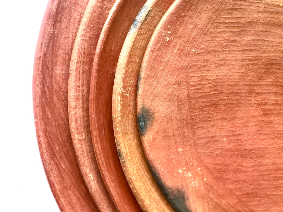 Mexico 1492: An impressive lunch or dessert plate, made from groovy, red clay and marked with random flame spots, adding character. Still showing the line marks of the artisan's work with the quartz stone. Lead free, unglazed. Thanks to the amazing, random pattern of the quartz polish lines and the flame marks, no two pieces are the same. 