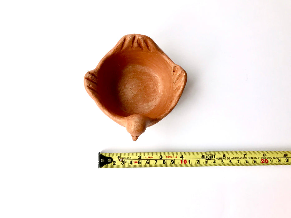 Mexico 1492: Graceful salsa bowl shaped as a bird with wings, made from red clay with a yellowish tone and marked with random flame spots, adding character. Best for serving salsa, appetizers, or salt and spices. Lead free, unglazed. Thanks to the artisanal nature of this handmade product, no two pieces are the same. 
