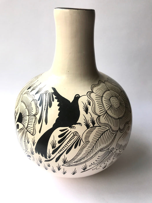 Mexico 1492: The off-white “cántaro” (pitcher), hand made out of clay, hand painted with jewels of the Michoacan nature,  and burnished to shine. Accompanied by a matching glass. Used for storing liquids, like water or wine.   “Cántaro” is a precious piece in every Mexican home, and a favorite way to store water. It is believed that water stays cool in a “cántaro” even on a hottest day.